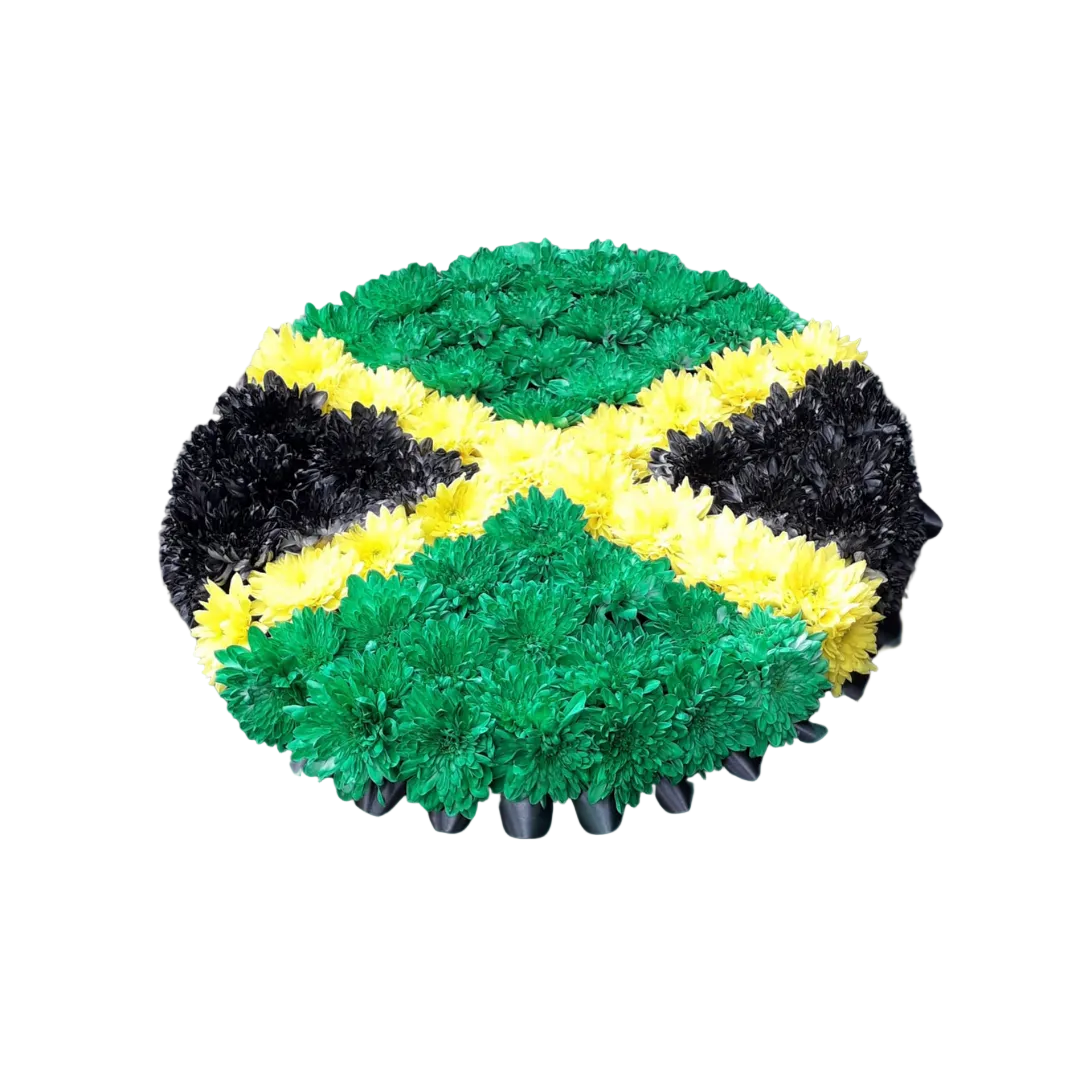 A heart-shaped floral arrangement in the colors of the Jamaican flag: green, yellow, and black.