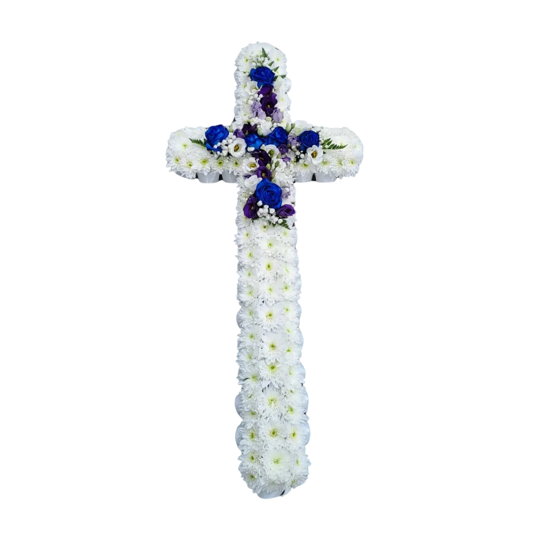 A floral cross tribute made of white flowers with blue accents, designed for funerals or memorials.