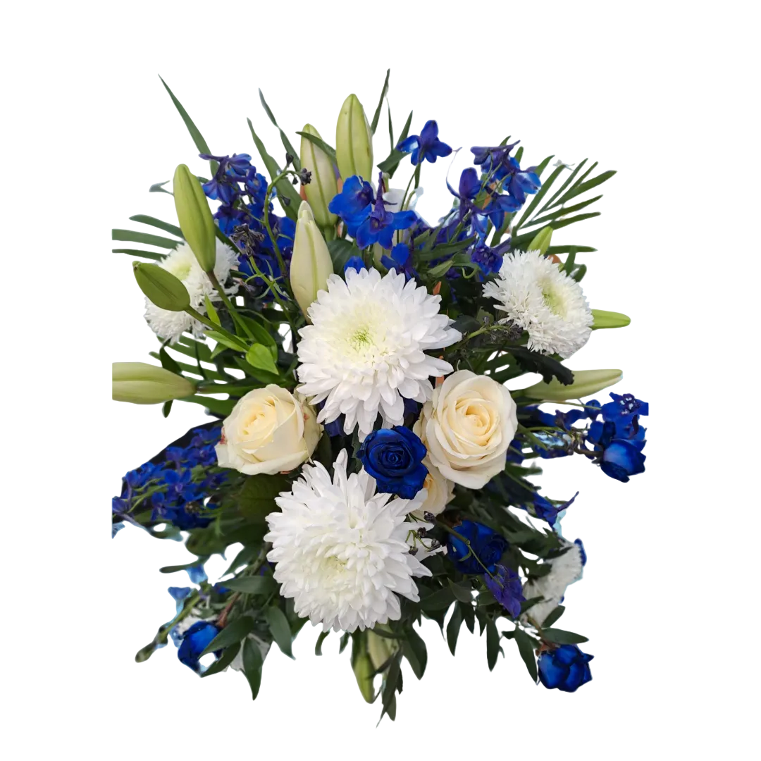 A floral arrangement featuring white roses and lilies with blue accents, designed for a church display.